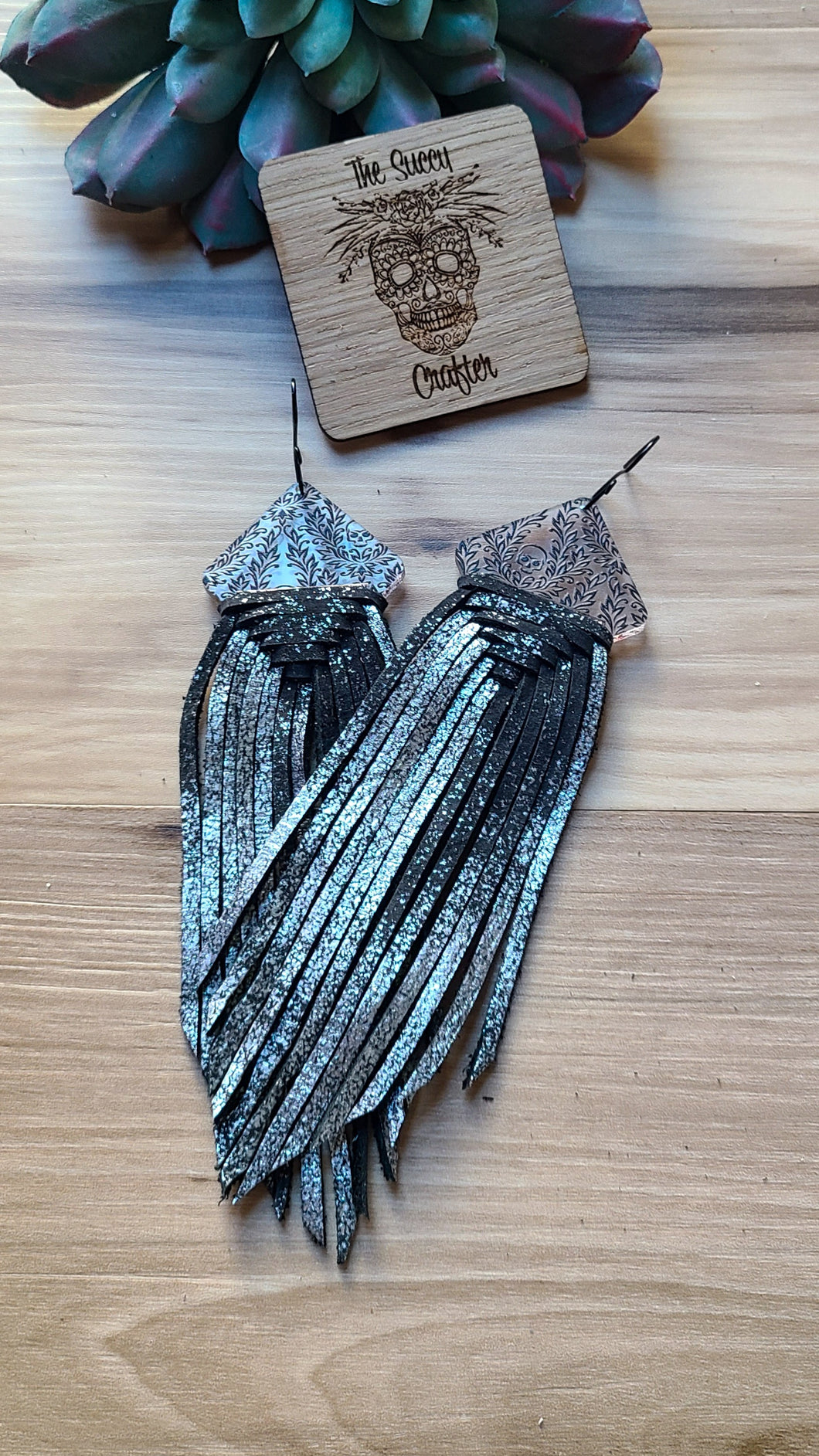 Black and silver woven fringe on acrylic skulls